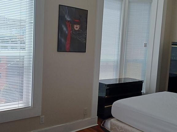 BEDROOM 4 WITH BAY WINDOW, 12 FOOT CEILINGS AND DECORATIVE FIREPLACE