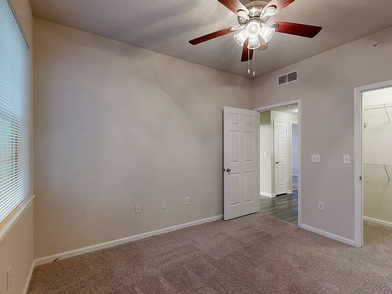 Spacious apartment Bedroom with Carpet Floor.