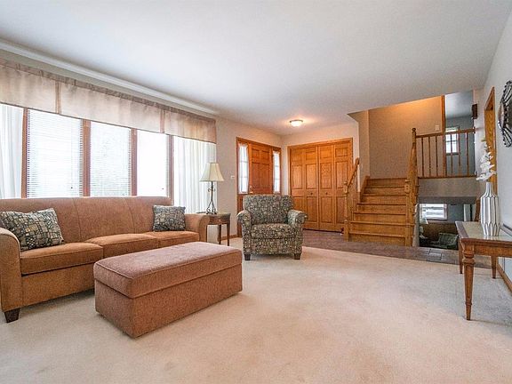 VIEW OF FORMAL LIVING ROOM & LARGE FOYER  WOOD STAIRS, WOOD RAILING & 6 PANEL DOORS!