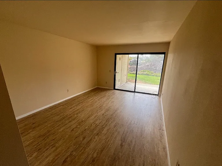 One of the master bedrooms; sliding door opens to the patio. Vertical blinds are now installed
