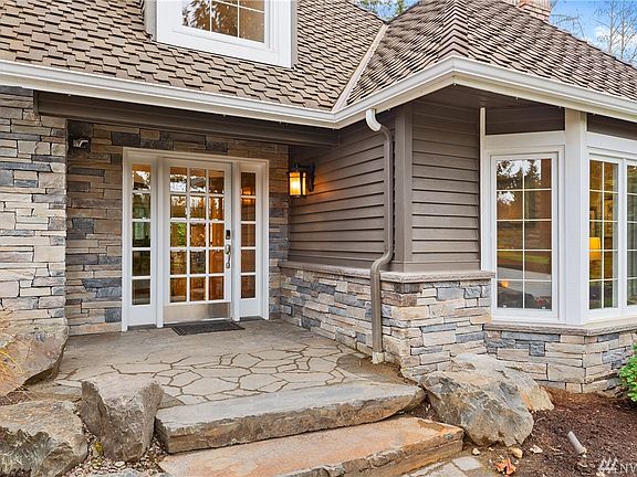 Extensive Bellgard Stone patios and walk ways grace both the front and the rear of the property.