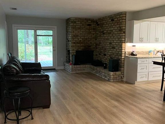 Den with fireplace off kitchen.