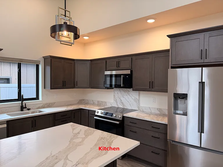 Kitchen with Granite Countertops, including Stainless Steel Bosch Refrigerator, Oven, Microwave and Dishwasher