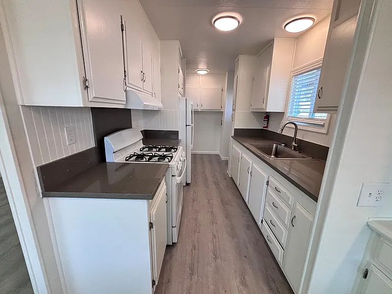 The kitchen is thoughtfully designed to blend functionality with everyday comfort. Featuring ample cabinetry and generous counter space, it provides plenty of room for meal preparation and storage.