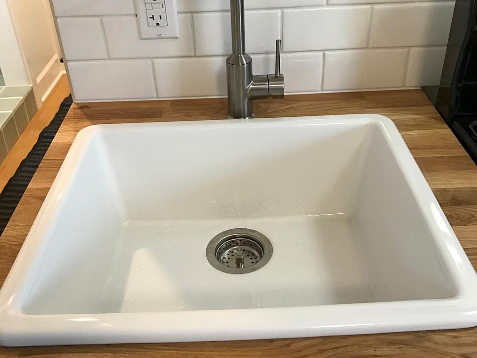 Farm house sink, ample water pressure and tile backsplash allow for full-on cooking.
