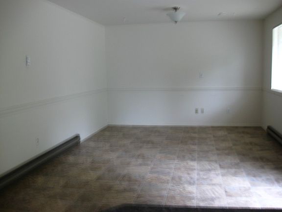 A Family Room with an eating area adjoins the Kitchen.
Sliders provide access to the lushly landscaped back yard with huge patio for entertaining family and friends.  Ball game anyone??