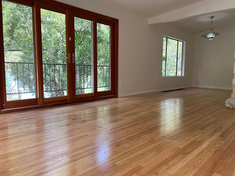 Livingroom and dining room. Doors open to front balcony.