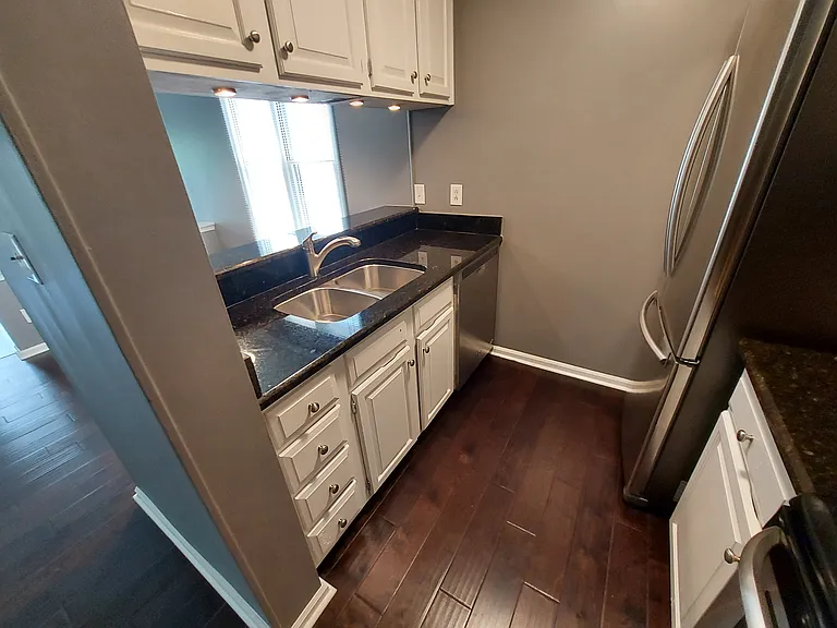 Great wood flooring, stainless steel refrigerator with a low chest and ice maker, French doors that open wide, great storage.