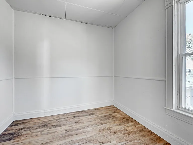 Main floor bedroom is large enough for a queen size bed, features a large closet with storage area and an East-facing window!