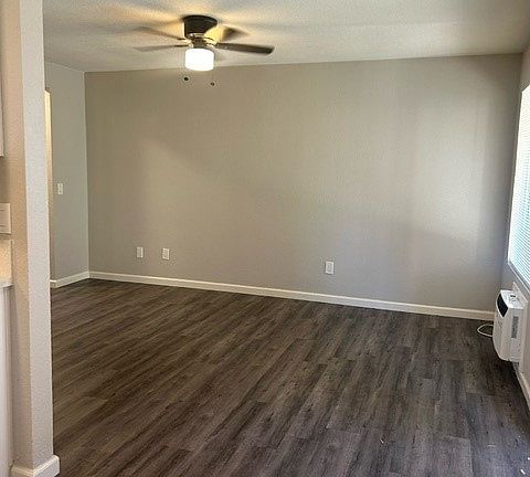 Open, spacious living room. New flooring, new paint. New ceiling fan. Window AC unit in Livingroom.