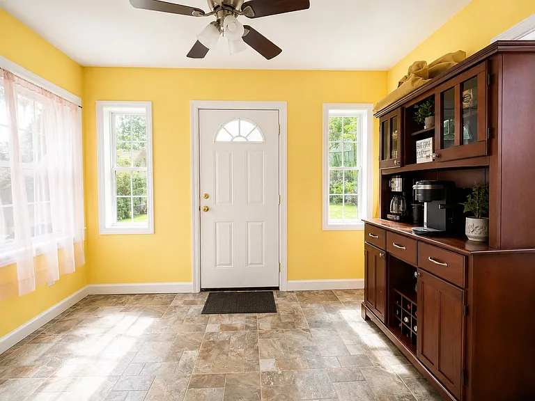 Bright sunroom leading to backyard. Perfect for extra storage and coffee room.