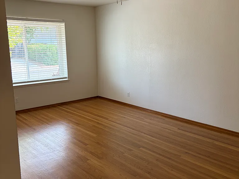 Front room leading to front door with overhead fan