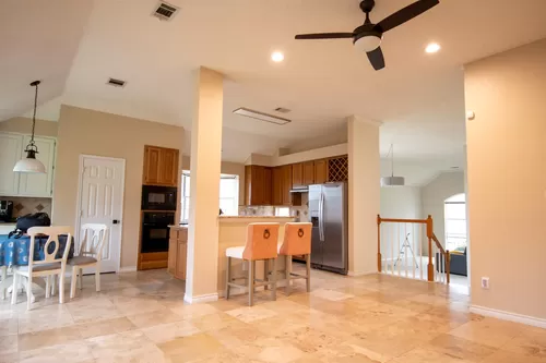 Bright light fills this spacious eat in kitchen and living room area, with high ceilings, a nice size pantry, and even a coffee nook - 704 Meadow Bend Ct