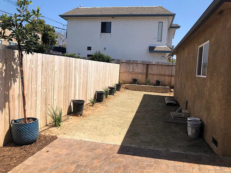 Excess yard area for games, raised garden beds or storage.