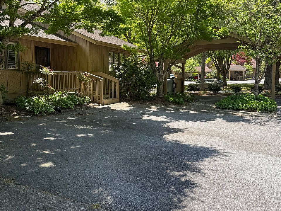 Front deck, parking space and carport.