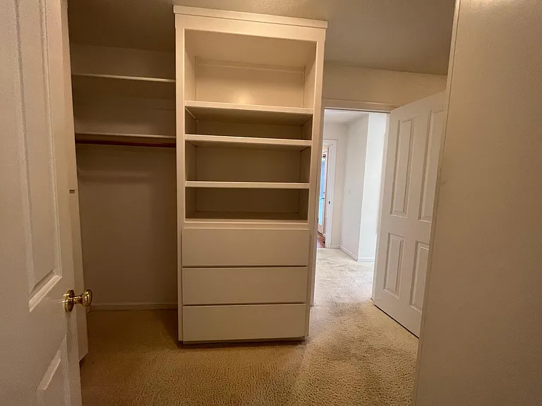 Extra-large primary walk-in closet has built-in organized storage.