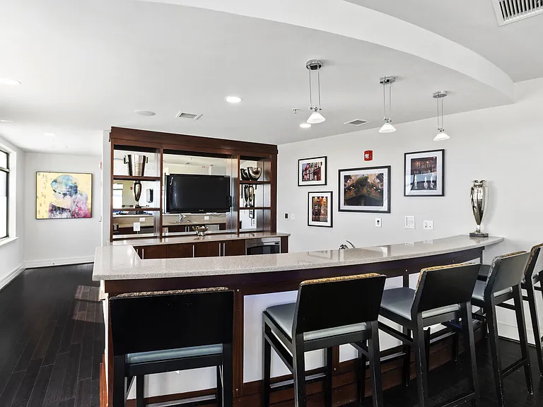 Exclusive resident lounge with kitchen, bar top, and billiards