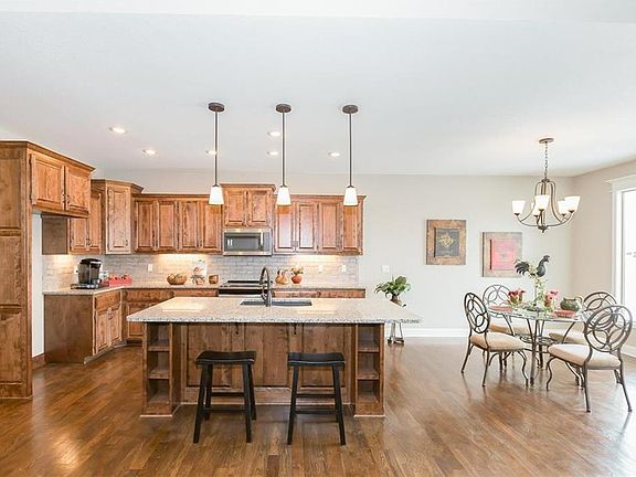 OPEN CONCEPT KITCHEN AND DINING AREA. HARDWOOD FLOORS THROUGHOUT THIS SPACE WITH TALL WINDOWS. (SIMULATED PHOTO)