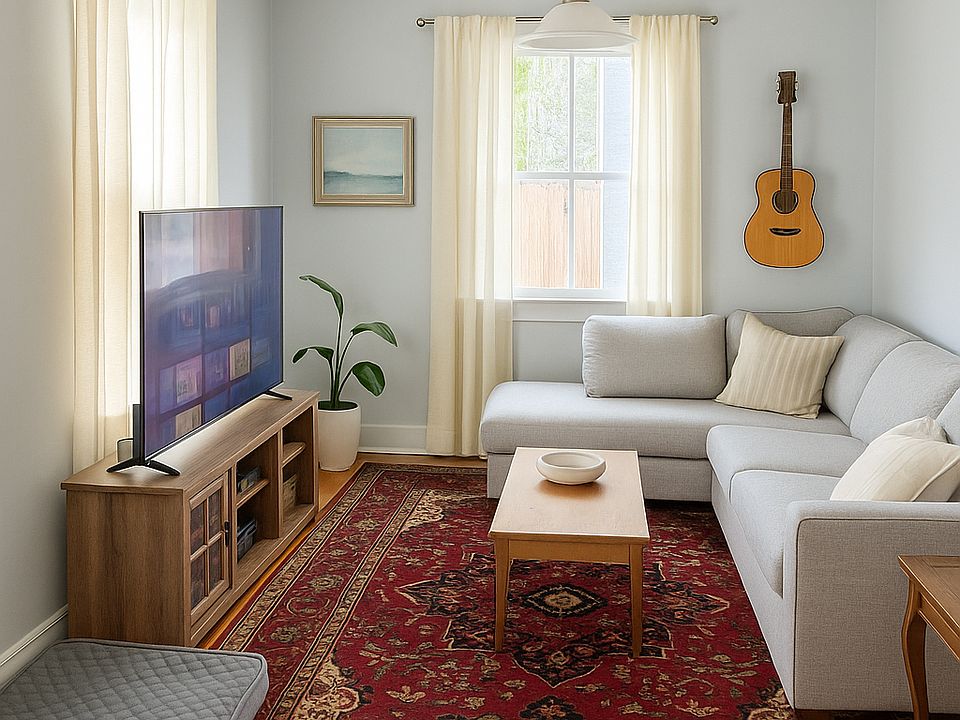Spacious living room with bright windows and tall ceilings