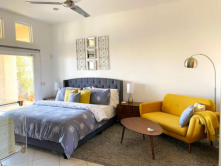 Yellow Bedroom: California King size bed, tall ceiling, walk-in closet, electric fireplace, back yard access, expansive desert and mountain views