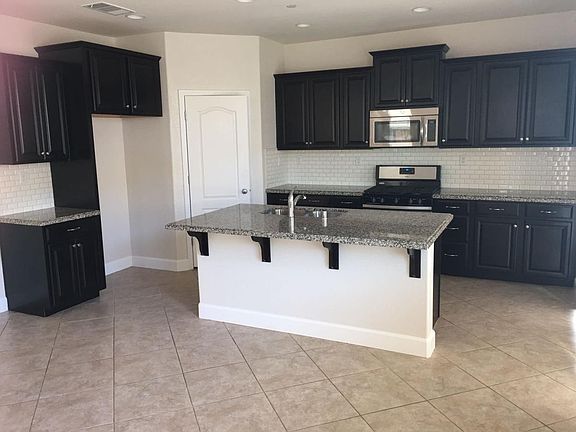 Granite island, counter top with splash, cabinets, closets for kitchen wares; tile floor