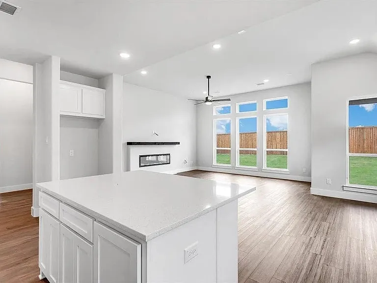 Kitchen island with a light-toned countertop and white cabinetry