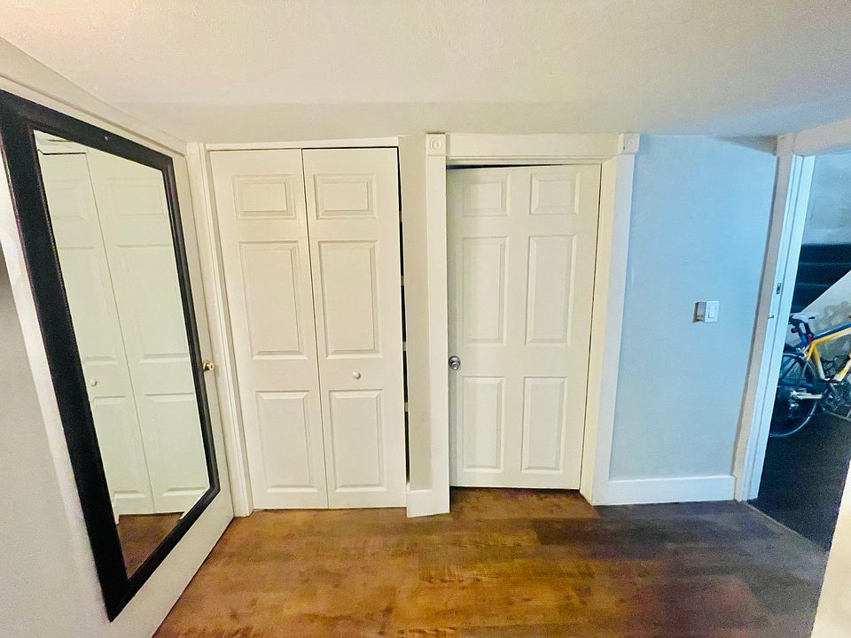 Hallway closet, mirror and entry to bath
