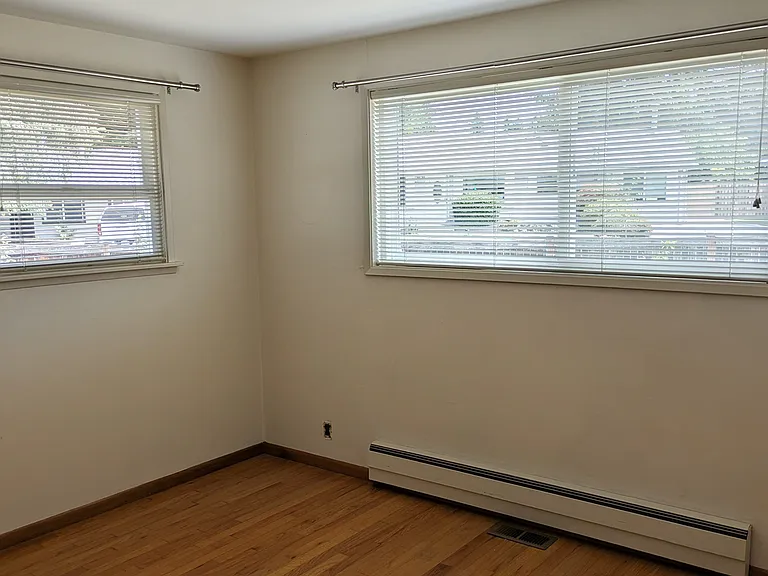 Corner bedroom with hardwood floors