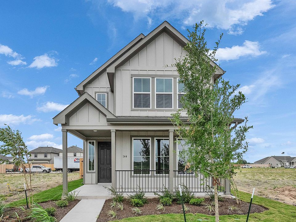 Elegant gabled roof and expansive windows define this new Spring Creek home, showcasing modern archi
