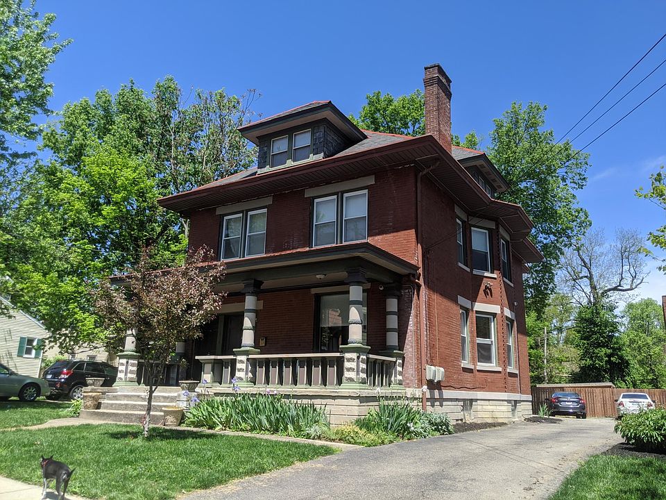 The House - large, deep front porch and driveway with 4 parking spaces.