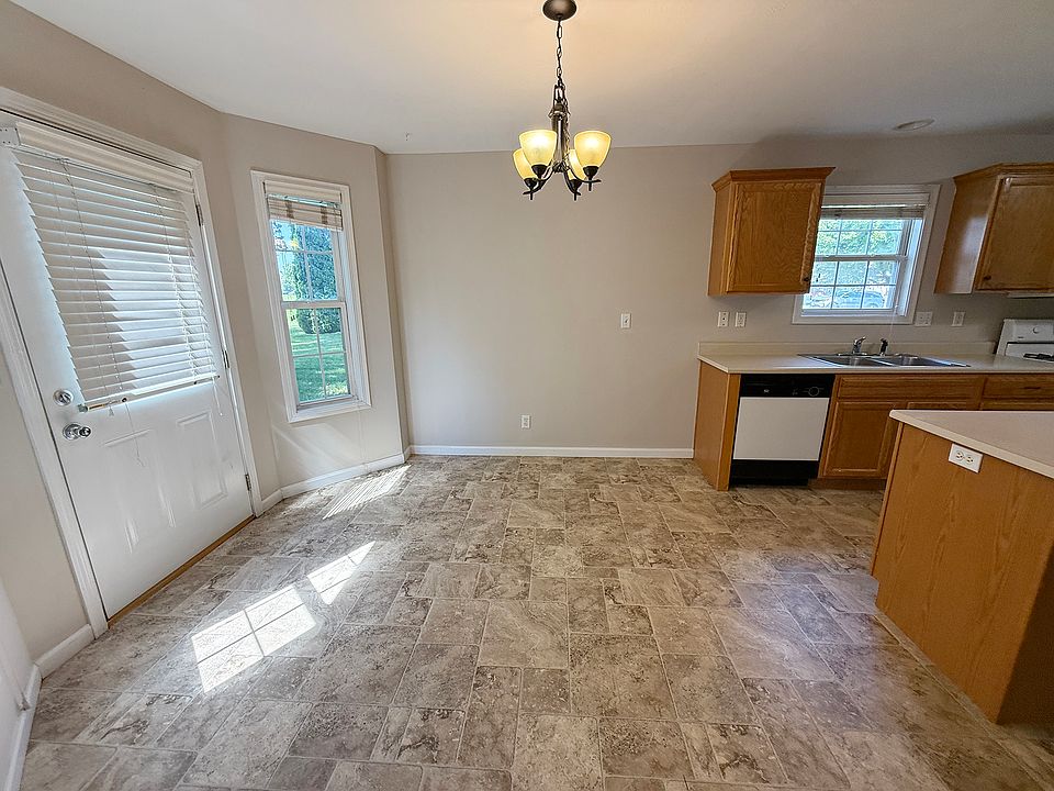 DINING AREA AND DOOR TO DECK & GREEN SPACE