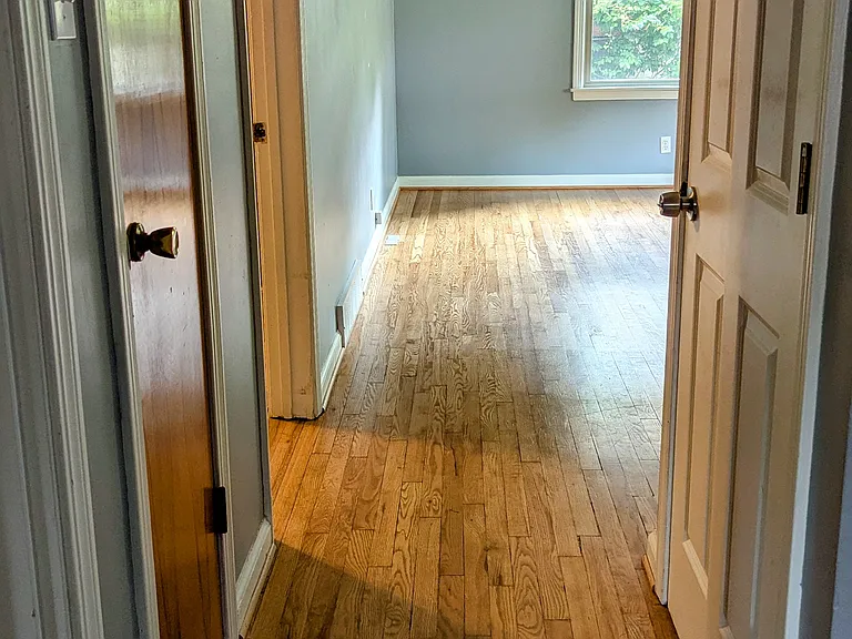 Hall leads from the living room to two bedrooms and a bath on the main floor. The hall closet is great for a additional storage.