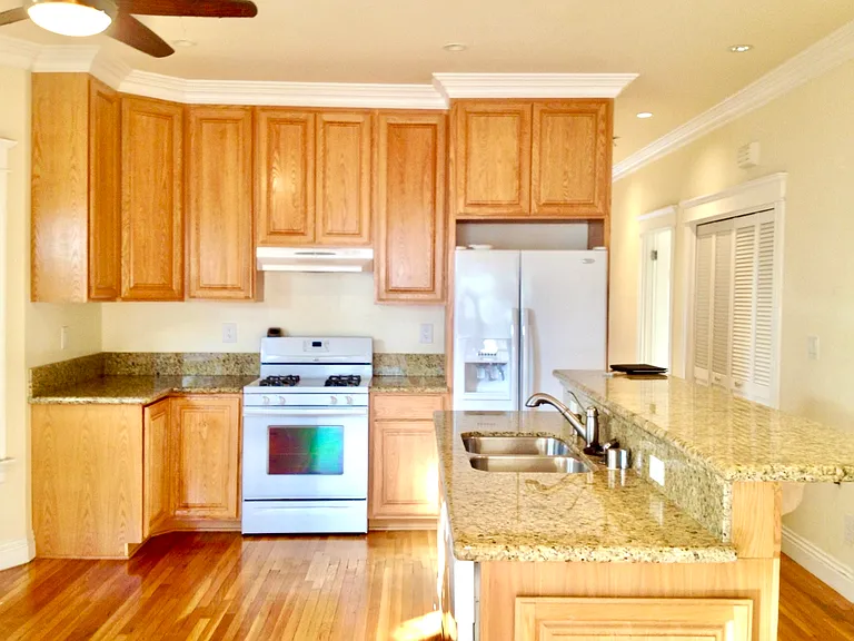 Modern fully-equipped kitchen in USC student rental with granite countertops and stainless appliances