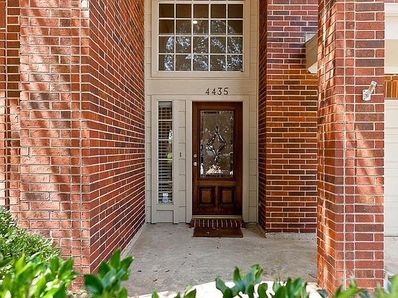 The entry way is surrounded by landscaping.