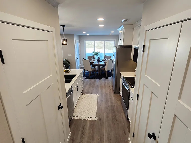 Hallway from garage entrance to kitchen. (Pictures are of another unit with similar finishes and features.)