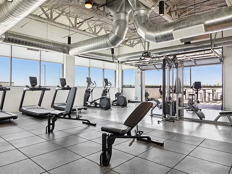 Train, recharge, and stay active in a fully equipped fitness center designed with open-air access and panoramic rooftop views.