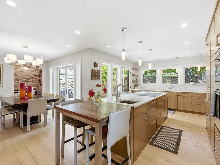 Spacious kitchen with lots of windows and patio entrance as well as adjacent dining room, and bar nook.