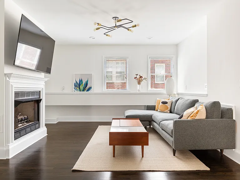 Main living room with fireplace and TV. New, comfortable sofa, and coffee table top lifts up for dining, scrolling, or working.