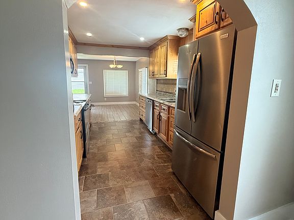 View from the formal dining room, through the kitchen and into the back kitchenette that leads to the backyard.