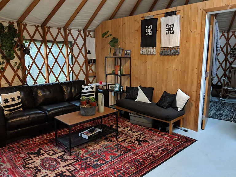 Living room with previous tenant's furnishings. It's very versatile, can be decorated in many styles.