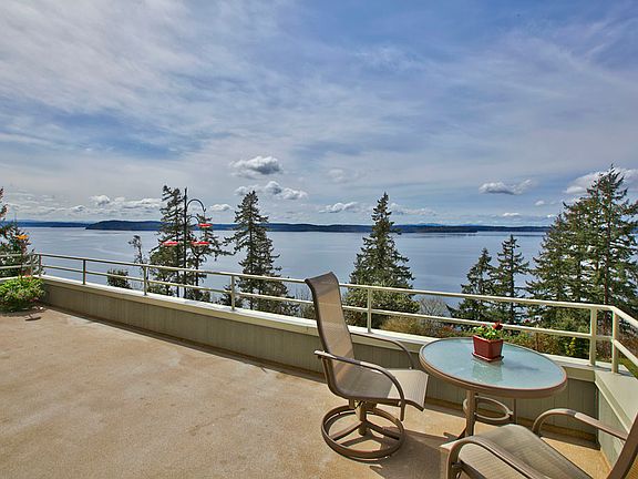 Mesmerizing views & sunsets grace this stylish home. Southwest exposure fills the house with sun and