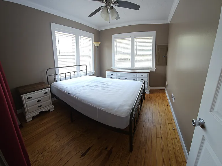 Master bedroom with queen size bed, nightstand and dresser