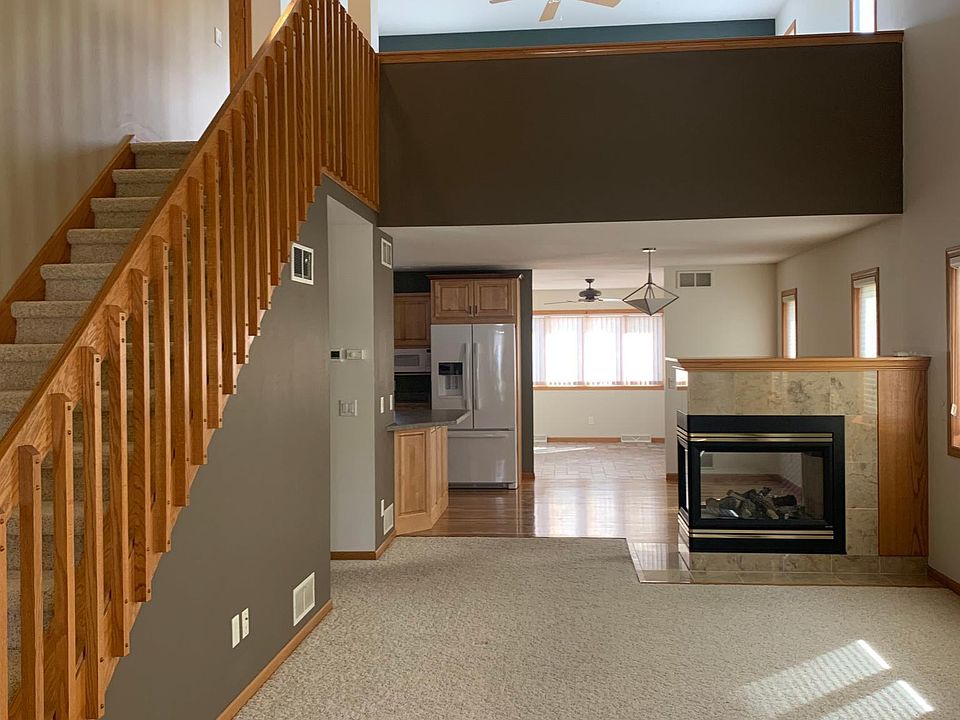 Large entry and living room with gas fireplace, leads into kitchen and dining room area with four season room at the end. Lots of light and high ceilings!