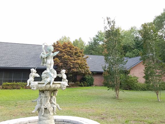 Back of house with fountain