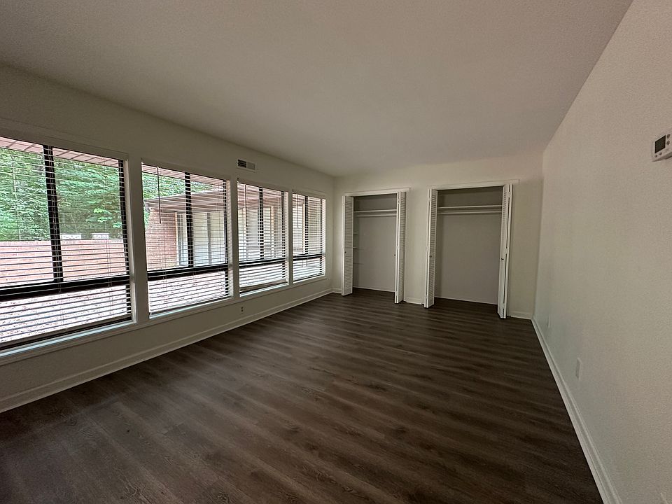 first bedroom with lots of natural light and two closets