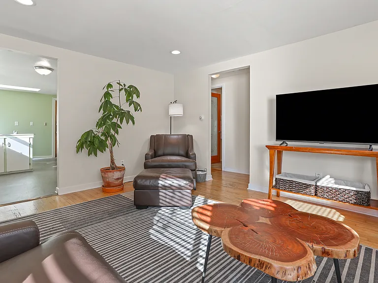 Livingroom looking southwest. Kitchen to left, hallway to bathroom to the right.