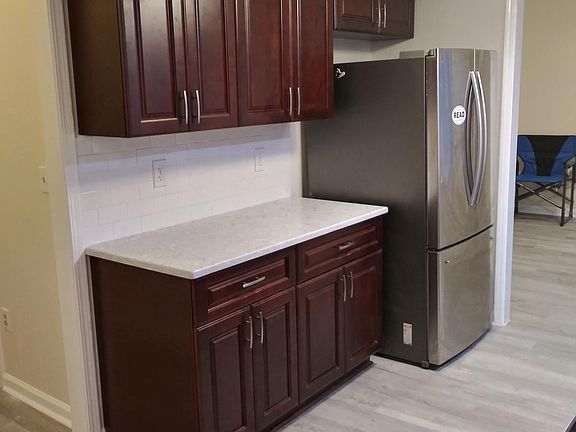 Kitchen with Cherry wood cabinets .