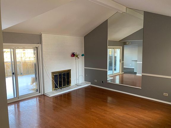 Living room with fireplace and overlooking patio