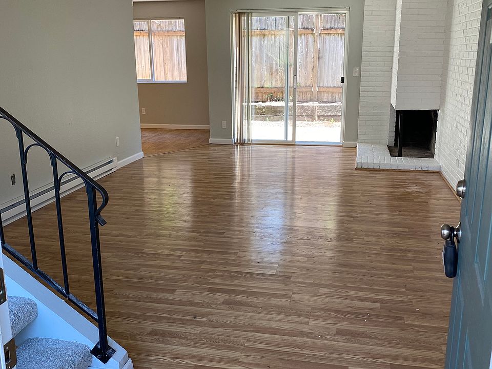 Large modern living room with wood laminate flooring and private outdoor space.