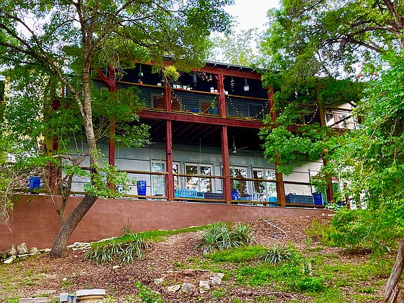 View of the Main house long porches from side, w/ swings and table/chairs for Poolside Suite guest' usage and enjoyment. Very private. Great views!